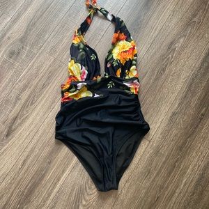 Bathing suit with halter and floral/black print. New without tags.